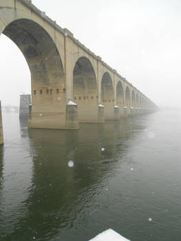 snow falls on the river