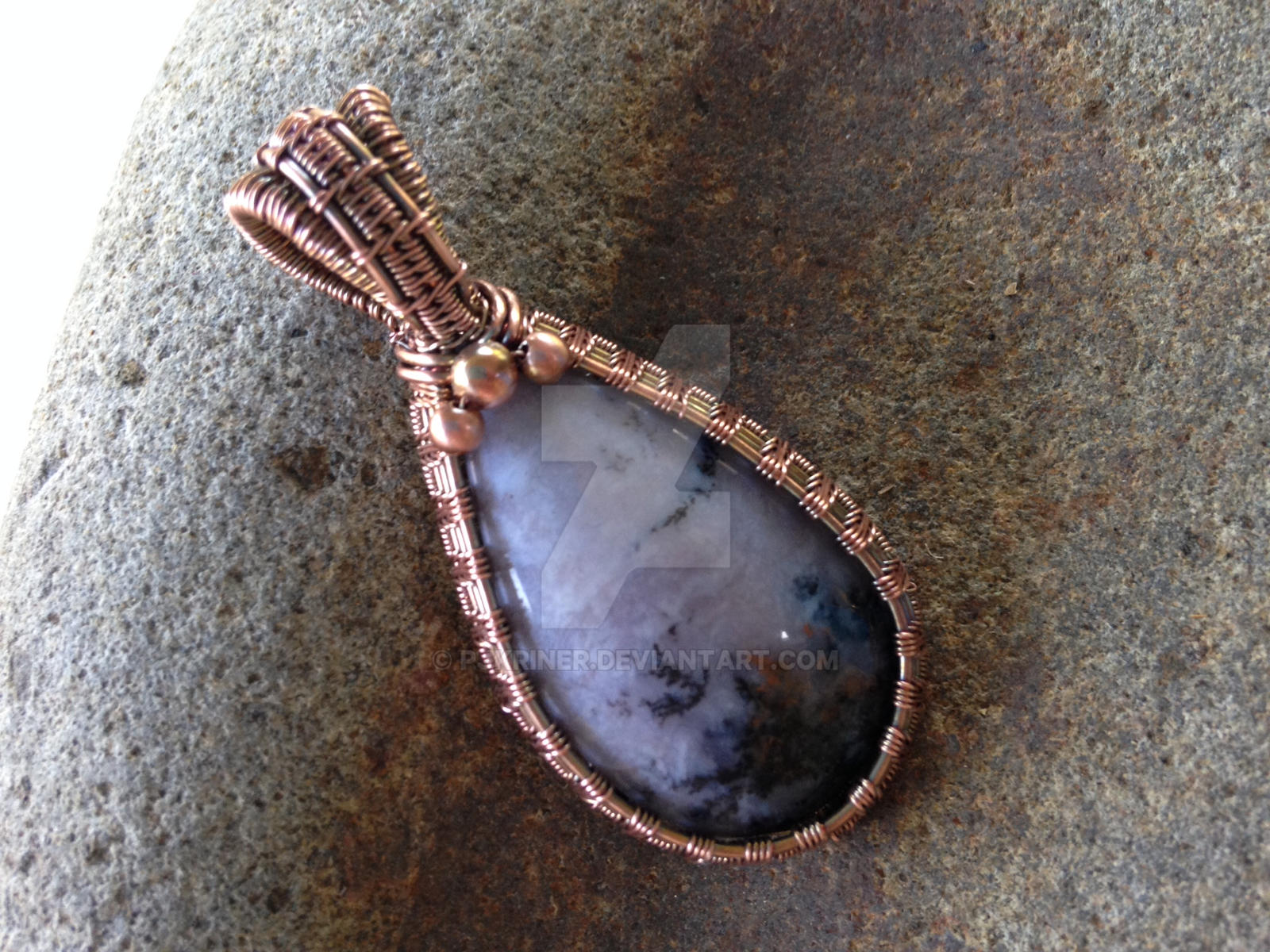 Sage Amethyst wrapped in woven copper wire.