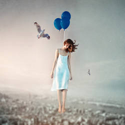 The girl, who hanging on balloons, and her seagull