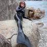 Smiling mermaid wife lounging on a Caribbean rock