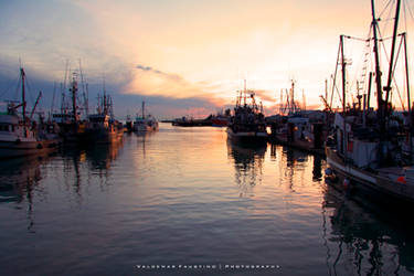 Fishing Village at Sunset by Val-Faustino