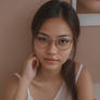 Cute nerdy bookworm Asian girl in glasses