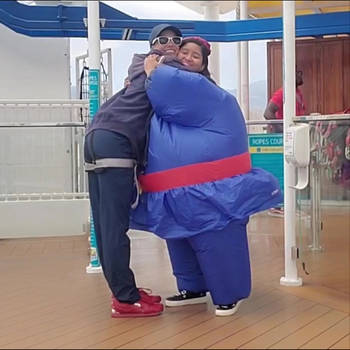Berry Violet in inflatable suit hugs a fan girl