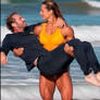 Sexy muscle woman cradles BF at beach (with sound)