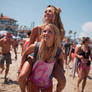 Young woman lifting her girlfriend at the beach