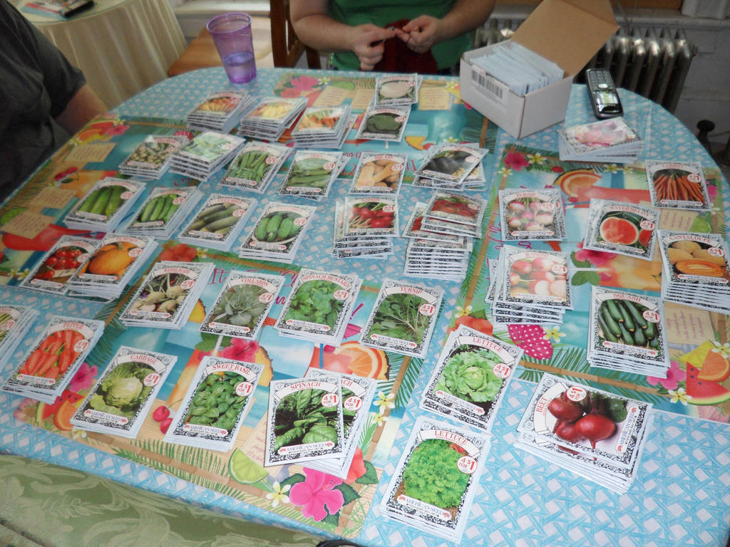 Seed packets spread out on a table by caspercrafts