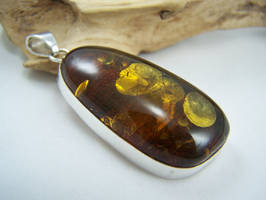 Gold flaked amber pendant by MadOnion1